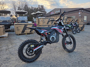Mazi Rocket 1300W electric kids dirt bike 3 quarter view showing rear suspension and off-road tires